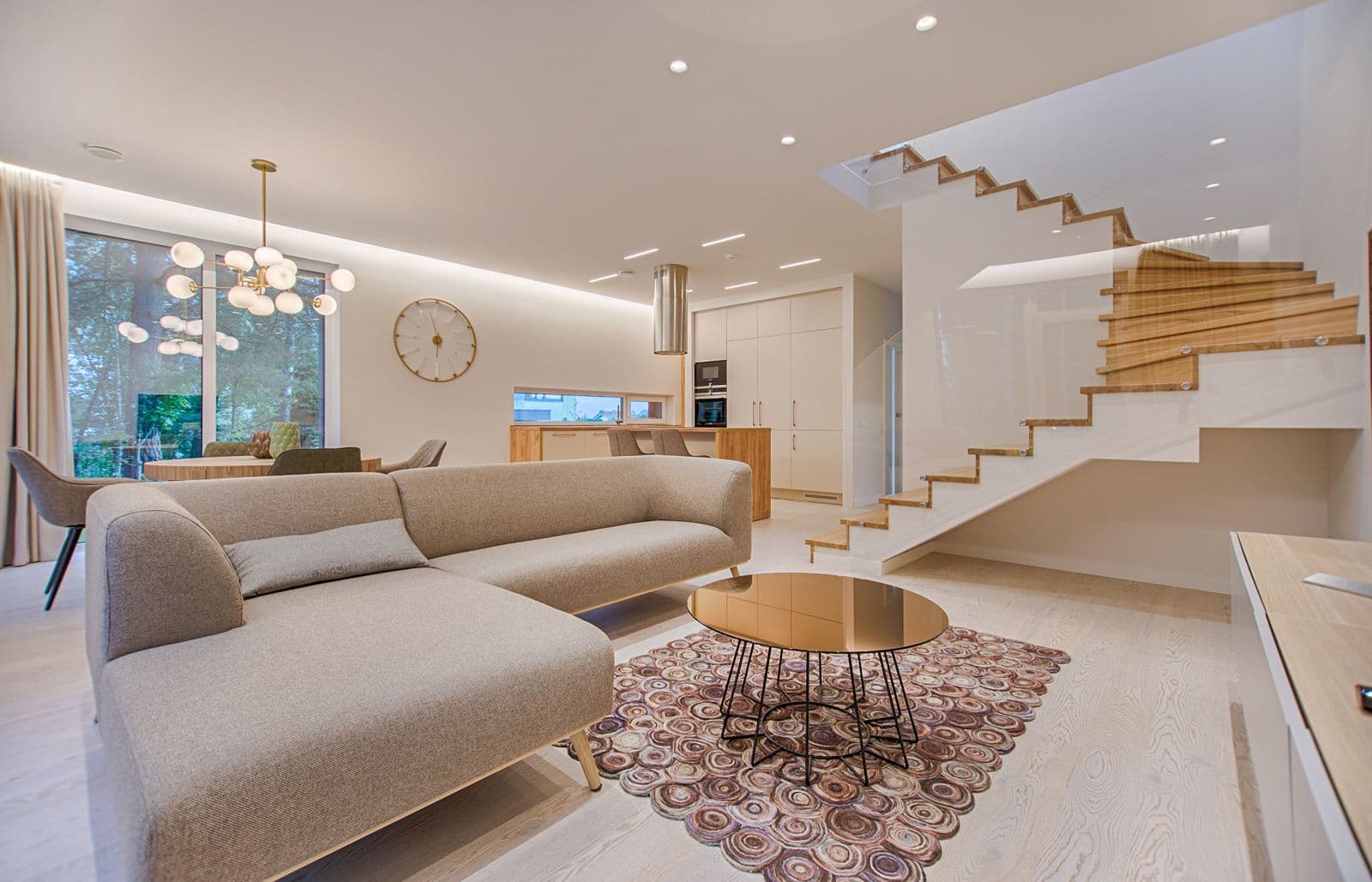 Light-filled interior with crafted oak staircase — the standard of finish carpentry we hold our work to